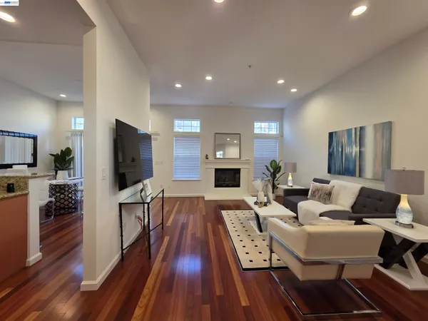 a living room with fireplace furniture and a flat screen tv