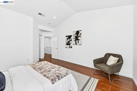 a bedroom with a bed and a chair