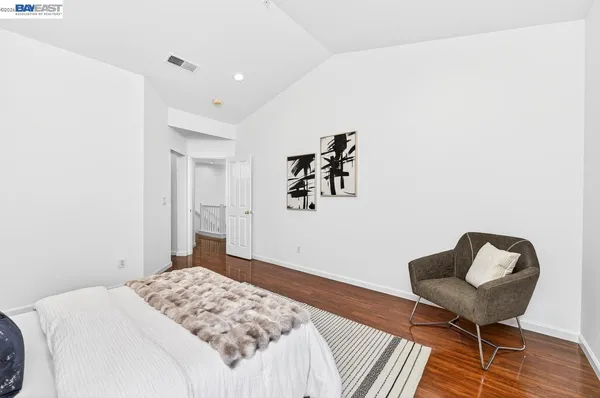a bedroom with a bed and a chair