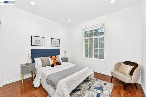 a bedroom with a bed and wooden floor