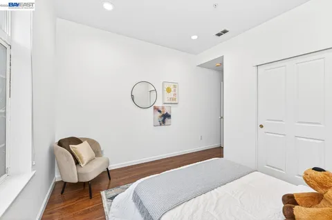 a bedroom with a bed and a chair