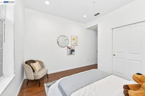 a bedroom with a bed and a chair