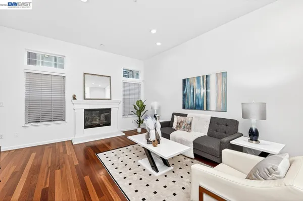 a living room with furniture a fireplace and a table