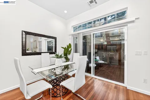 a living room with a large window and furniture
