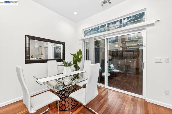 a living room with a large window and furniture