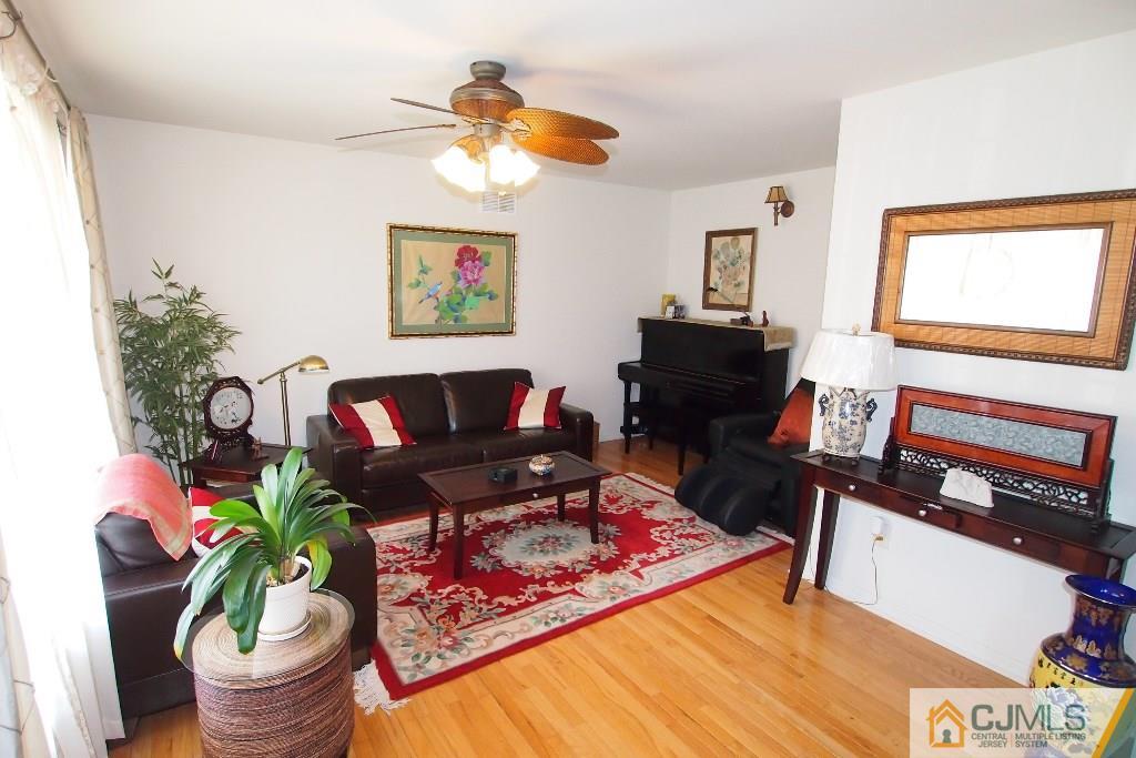 983 Cox Road North Brunswick, NJ 08902 - Photo 3 of 24 a living room with furniture and a flat screen tv