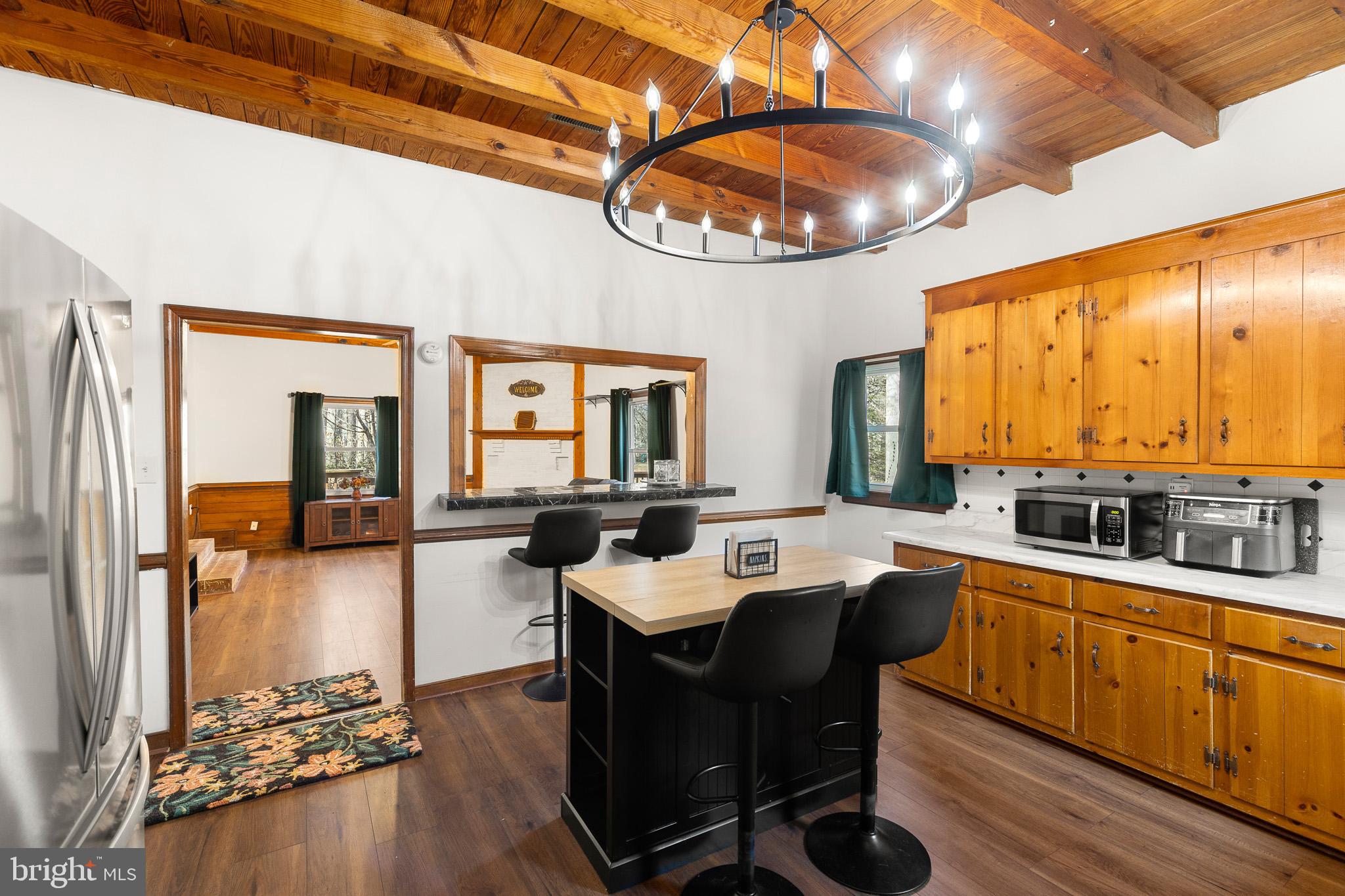 5708 Lakeview Road Quinton, VA 23141 - Photo 15 of 53 a kitchen with a table chairs stove and cabinets