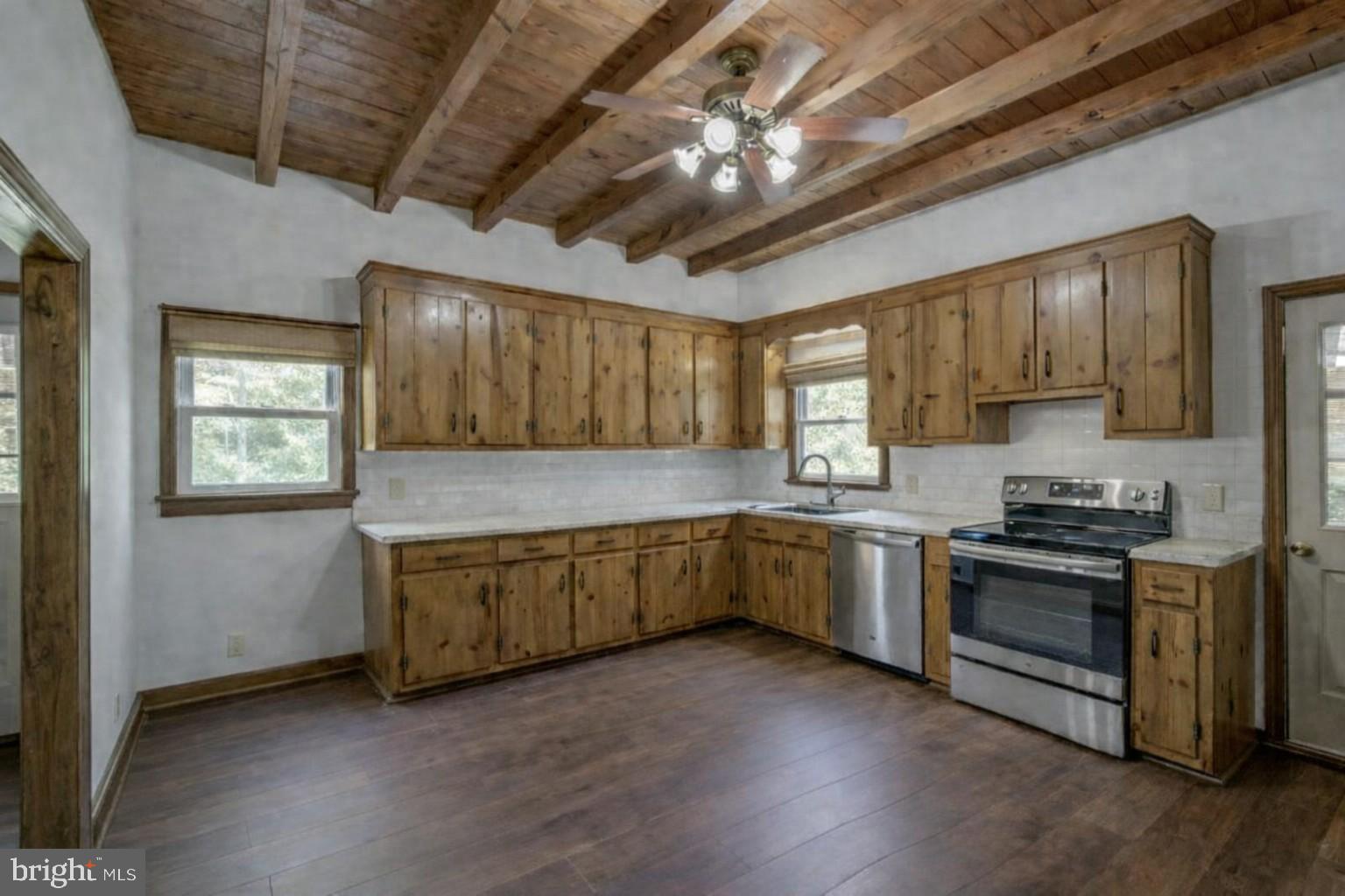 5708 Lakeview Road Quinton, VA 23141 - Photo 46 of 53 a kitchen with granite countertop a stove top oven a sink dishwasher and wooden cabinets with wooden floor