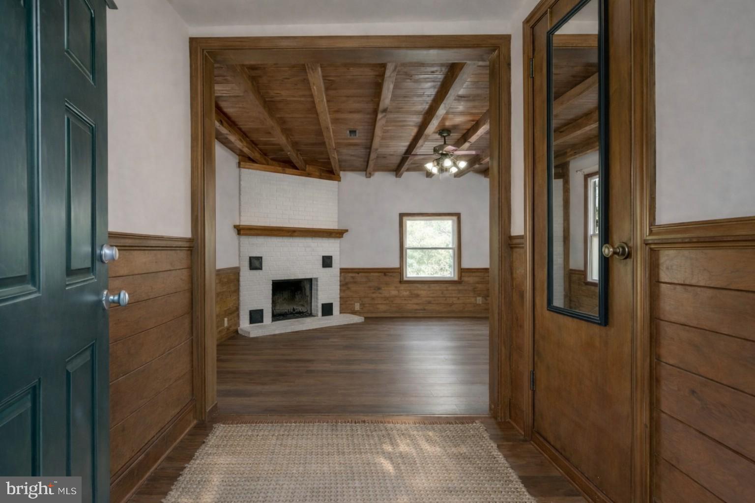 5708 Lakeview Road Quinton, VA 23141 - Photo 5 of 53 a view of a hallway with wooden floor and a fireplace