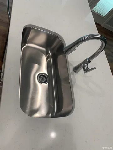 a view of empty room with wooden floor and fireplace