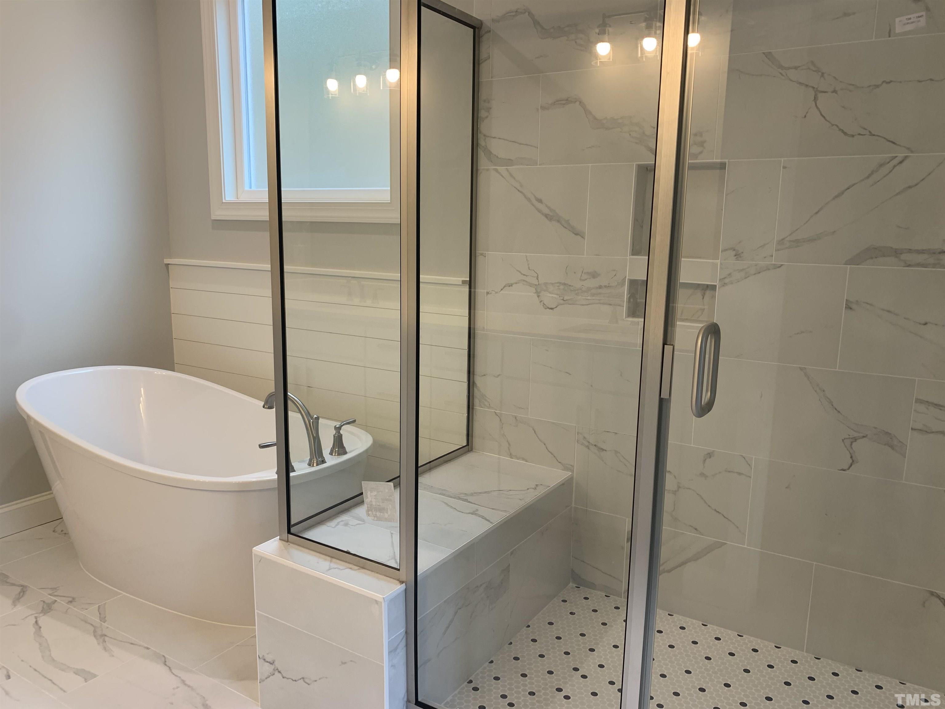 245 Whistlers Cove Louisburg, NC 27549 - Photo 19 of 27 a bathroom with a bathtub and shower