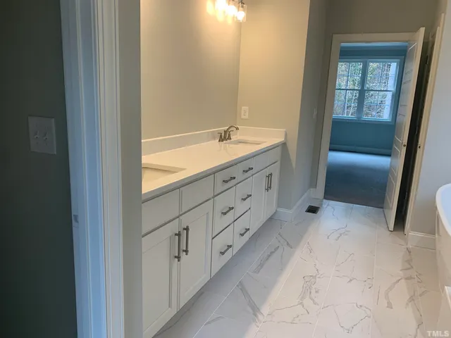 a bathroom with a sink and vanity