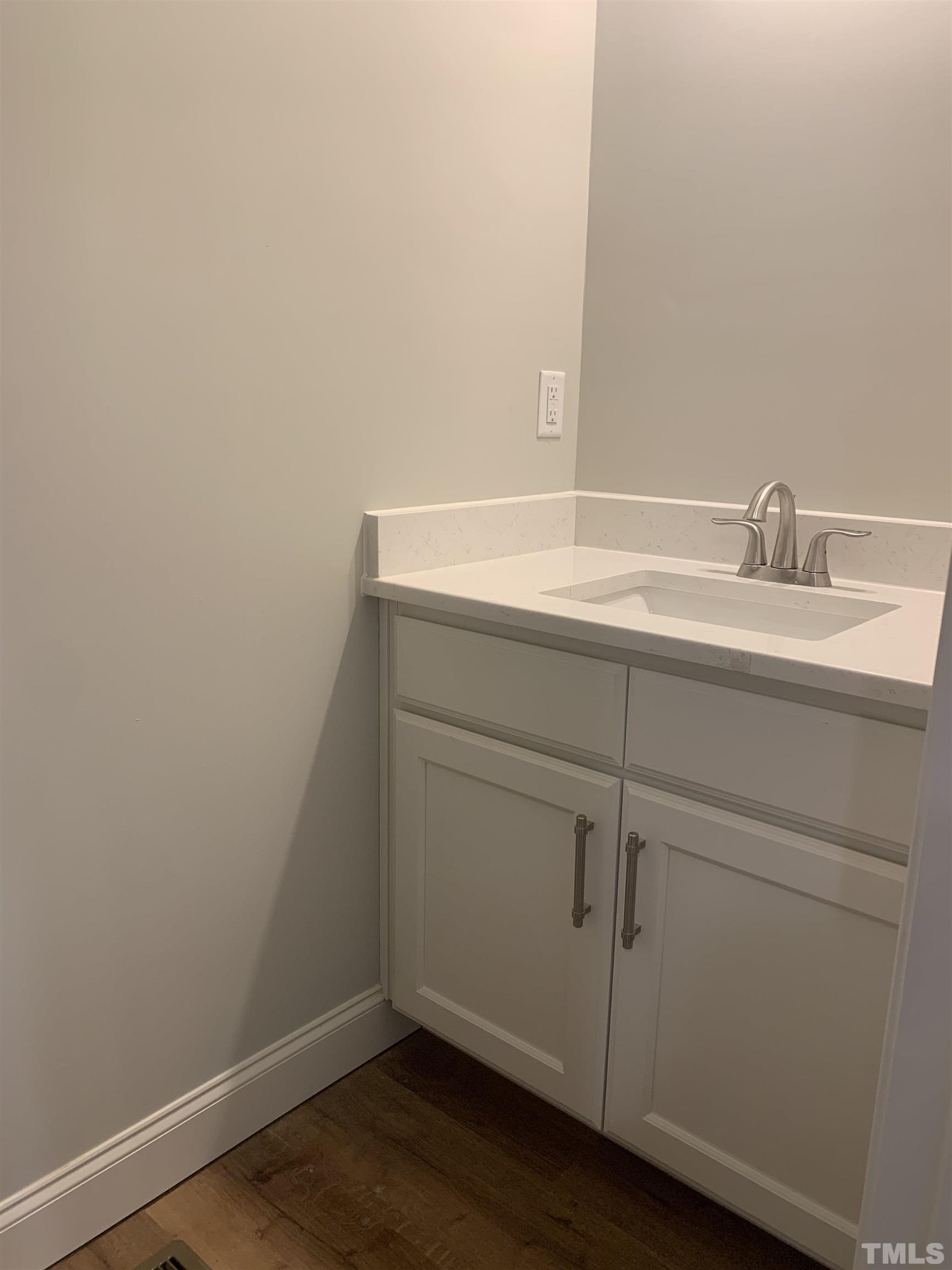 245 Whistlers Cove Louisburg, NC 27549 - Photo 22 of 27 a bathroom with a sink and vanity