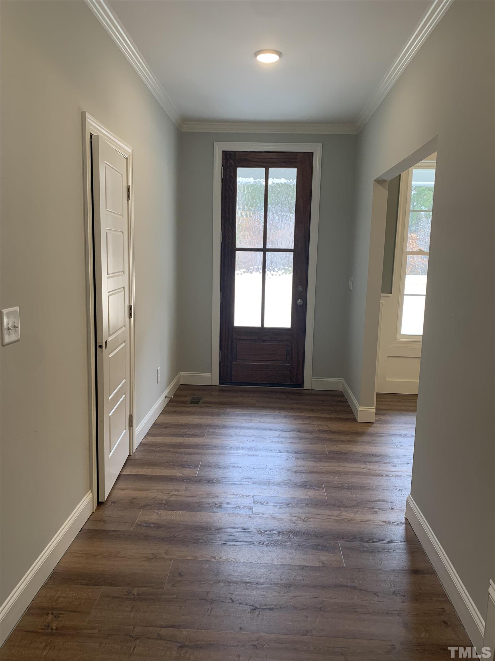 245 Whistlers Cove Louisburg, NC 27549 - Photo 6 of 27 wooden floor in an empty room with a window