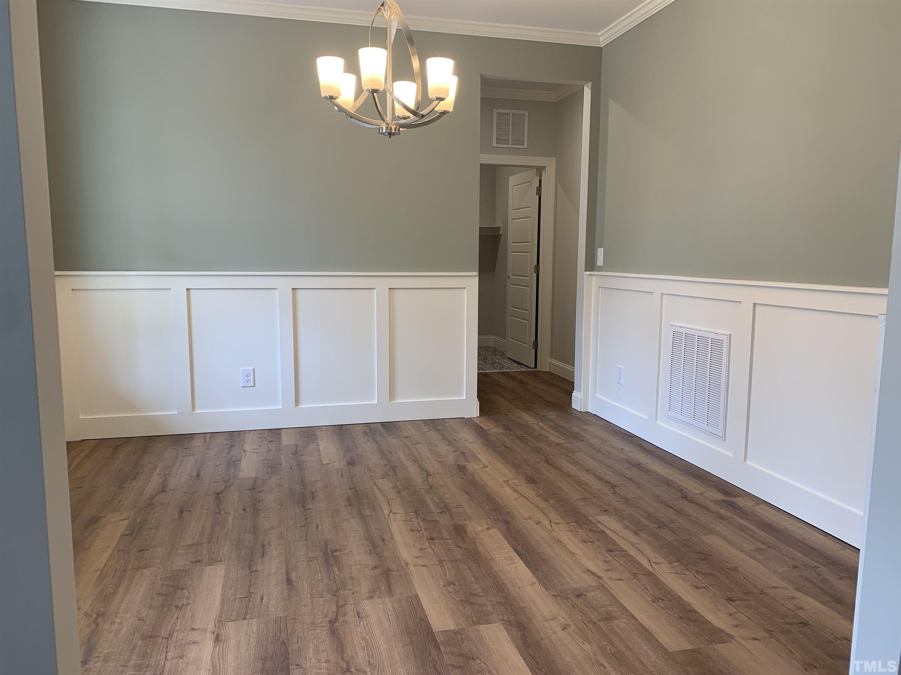 245 Whistlers Cove Louisburg, NC 27549 - Photo 8 of 27 a view of an empty room with wooden floor