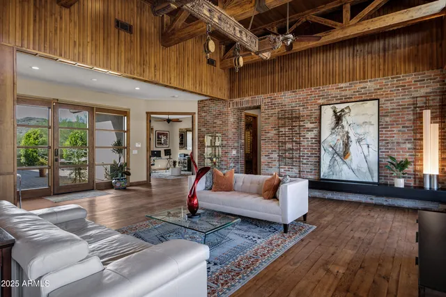 a living room with furniture rug and wooden floor