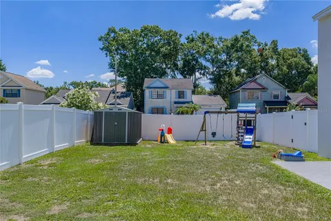 a view of a house with a yard and potted plants