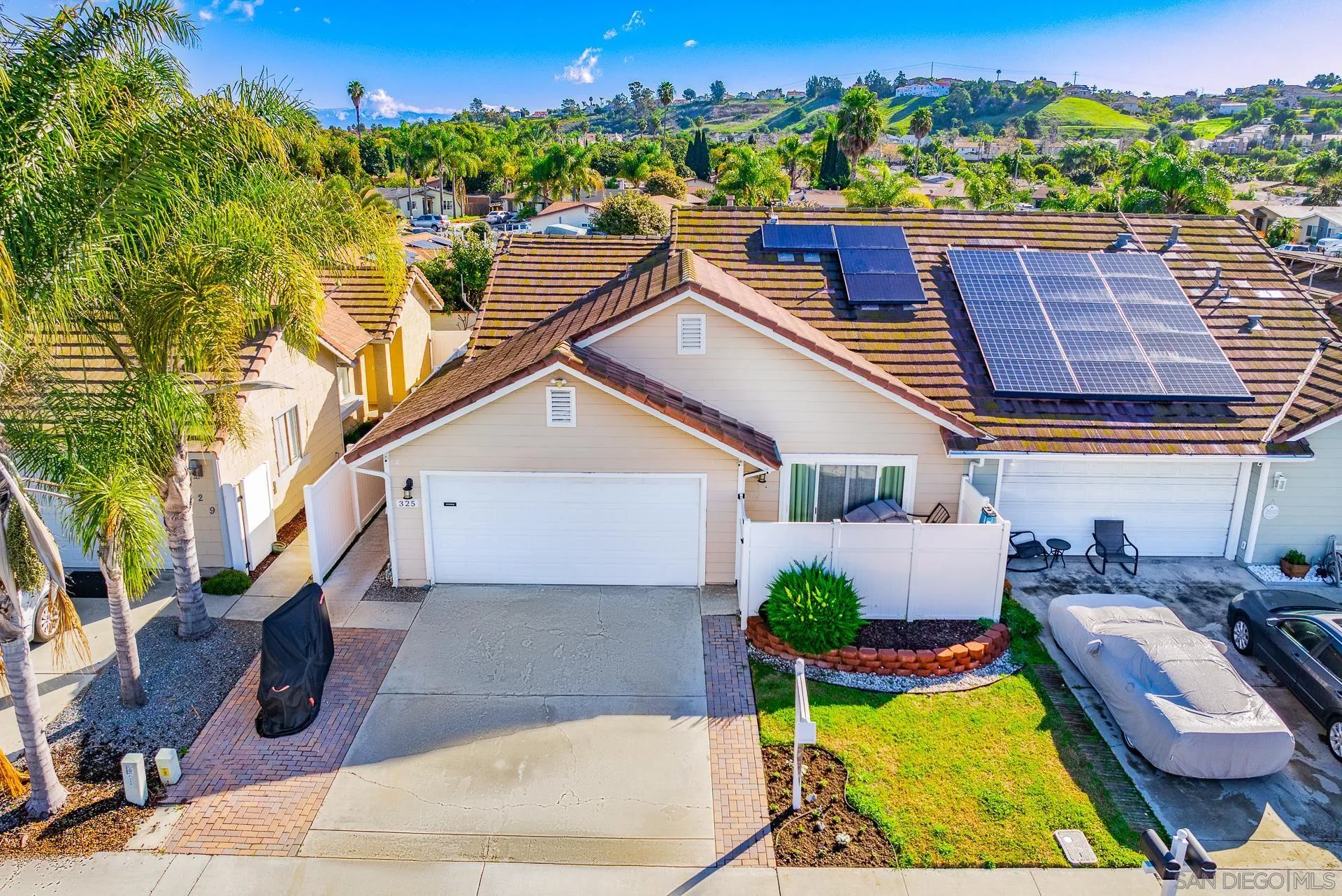 a view of a house with pool and chairs