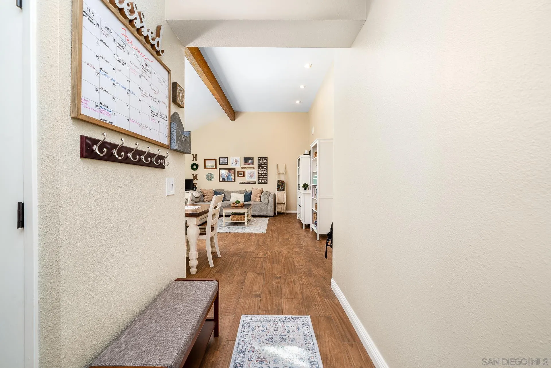 325 Wind Flower Way Oceanside, CA 92057 - Photo 11 of 41 a hallway with table and chairs