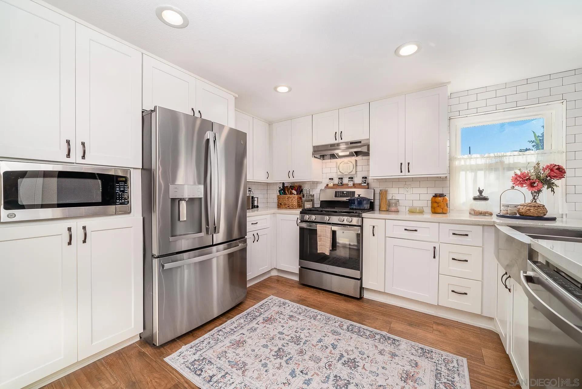 325 Wind Flower Way Oceanside, CA 92057 - Photo 14 of 41 a kitchen with a refrigerator stove and sink