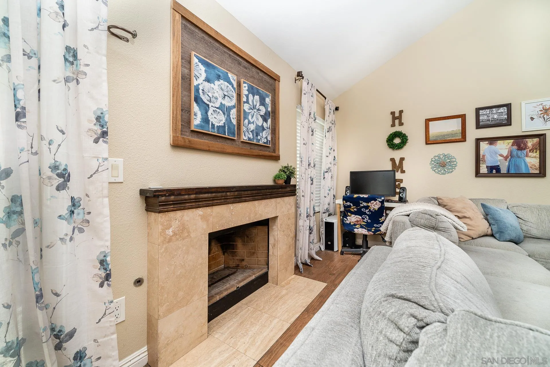 325 Wind Flower Way Oceanside, CA 92057 - Photo 20 of 41 a living room with furniture a fireplace and a painting
