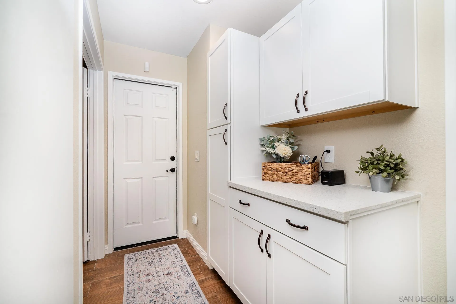325 Wind Flower Way Oceanside, CA 92057 - Photo 24 of 41 a view of kitchen with white cabinets and potted plant