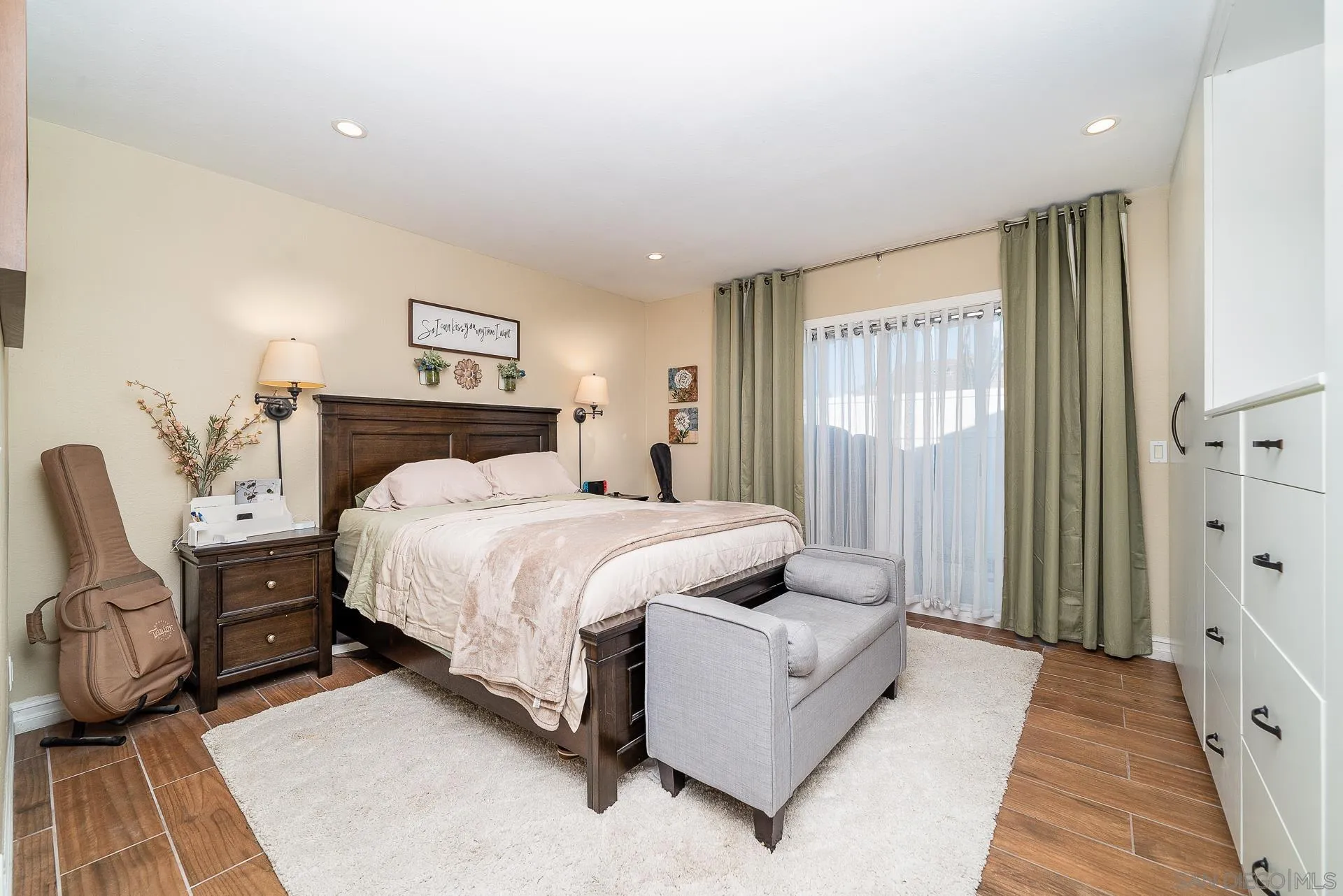 325 Wind Flower Way Oceanside, CA 92057 - Photo 27 of 41 a bedroom with a bed couch and a window