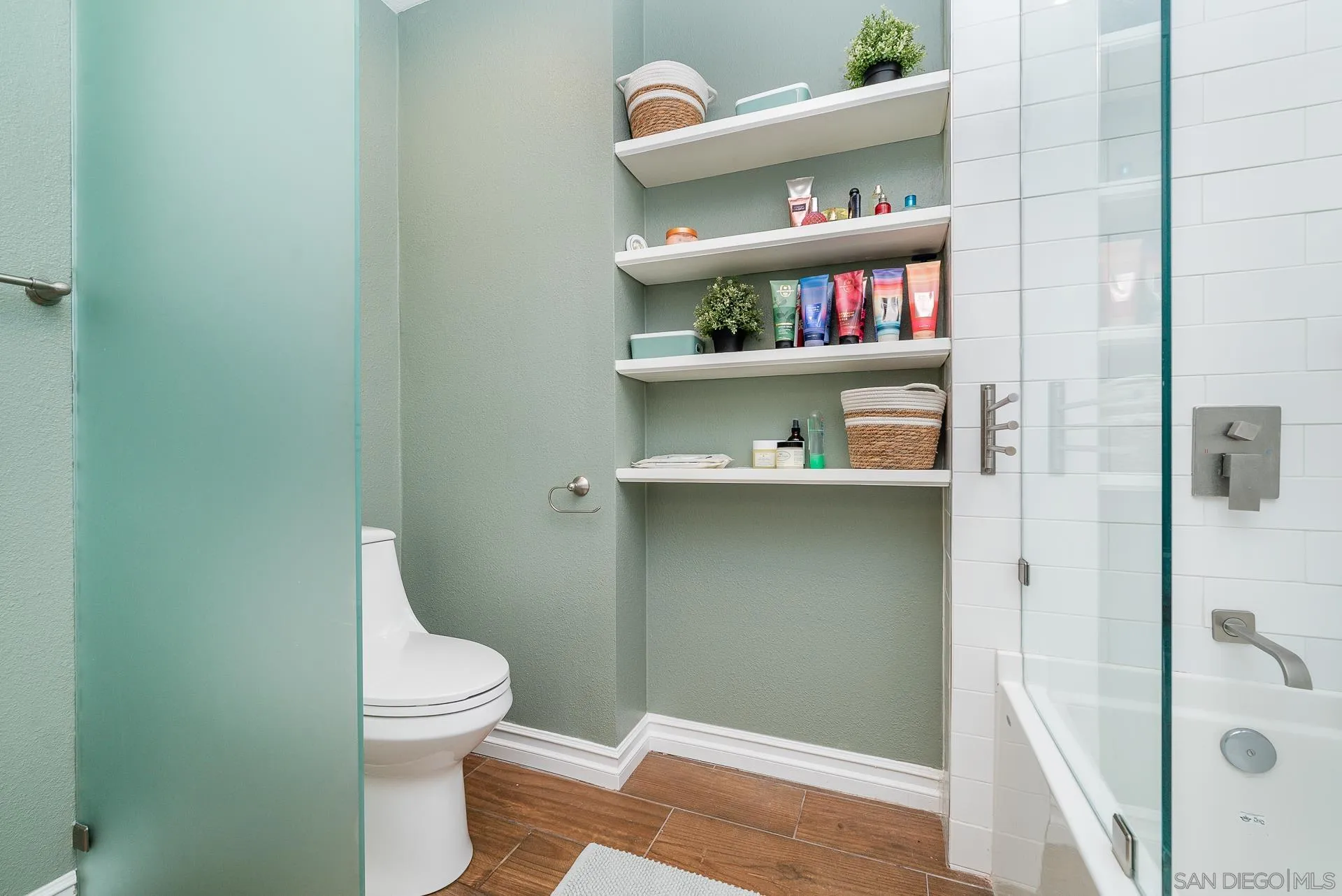 325 Wind Flower Way Oceanside, CA 92057 - Photo 30 of 41 a bathroom with a toilet and a shower