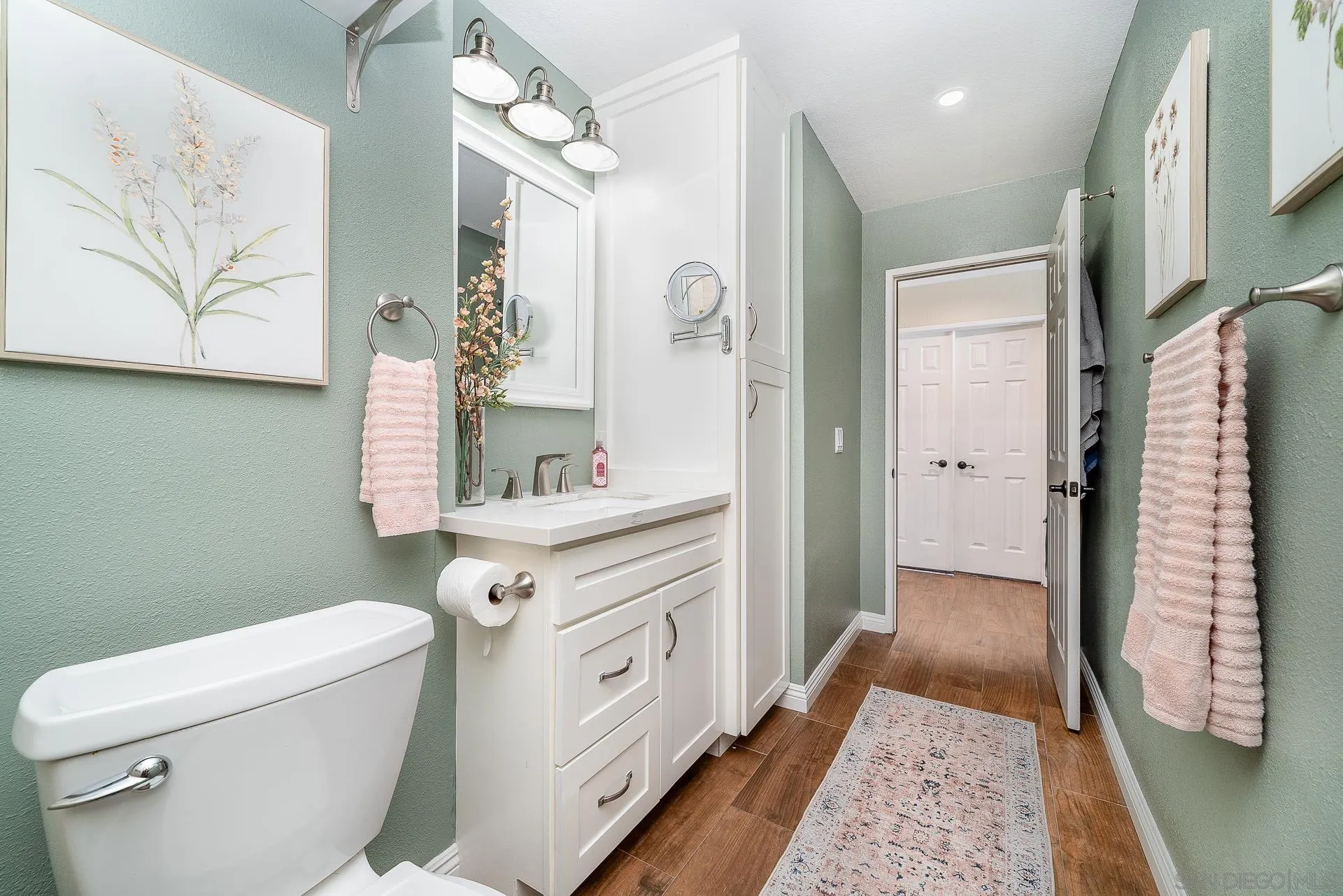 325 Wind Flower Way Oceanside, CA 92057 - Photo 35 of 41 a bathroom with a sink a toilet and shower