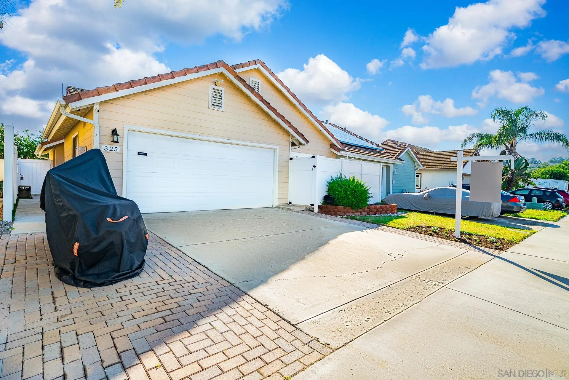 325 Wind Flower Way Oceanside, CA 92057 - Photo 5 of 41 a view of a house with a small yard and sitting area