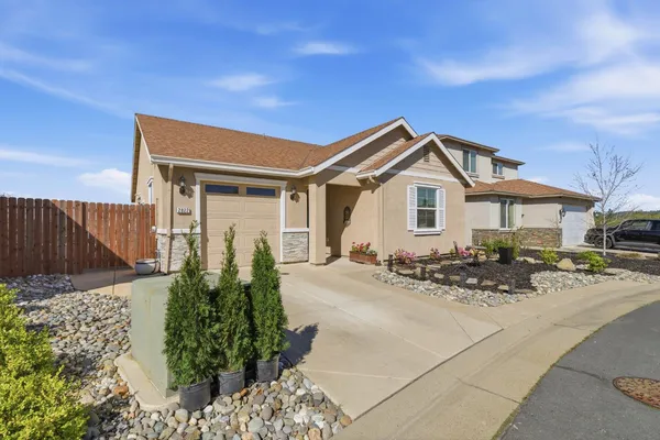 a view of a house with wooden fence