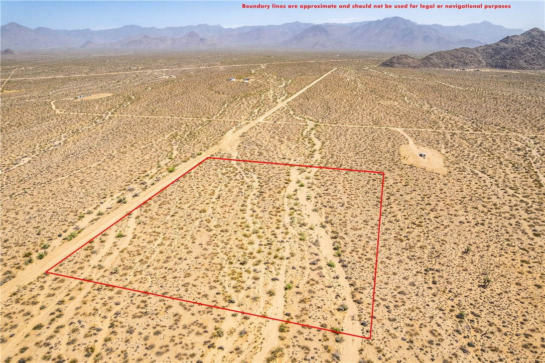 0 East Arroyo Road Yucca, AZ 86438 - Photo 11 of 25 Expansive lot featuring desert vegetation and distant mountain views