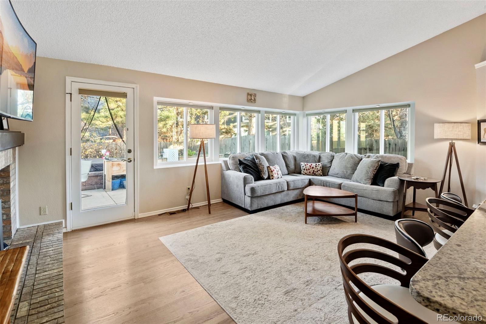 8482 Oak Street Arvada, CO 80005 - Photo 11 of 34 a living room with furniture and floor to ceiling windows