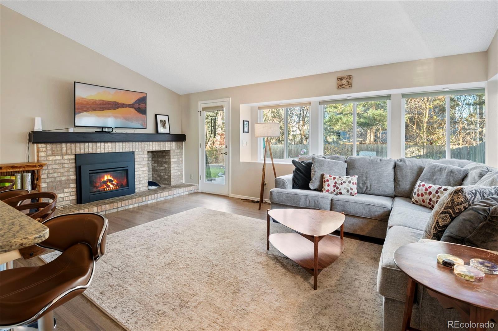 8482 Oak Street Arvada, CO 80005 - Photo 12 of 34 a living room with furniture and a fireplace