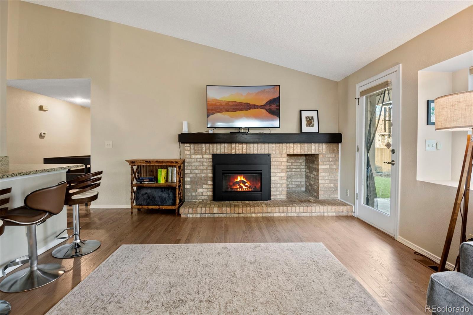 8482 Oak Street Arvada, CO 80005 - Photo 13 of 34 a living room with furniture and a fireplace