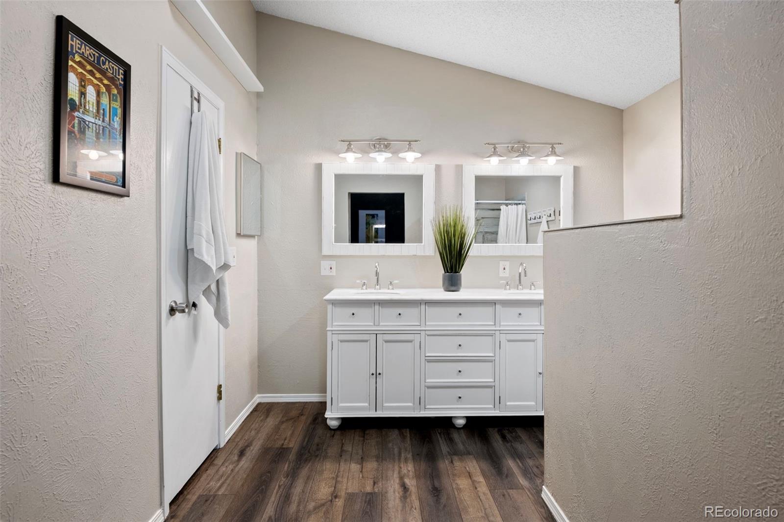 8482 Oak Street Arvada, CO 80005 - Photo 20 of 34 a bathroom with a sink mirror and window