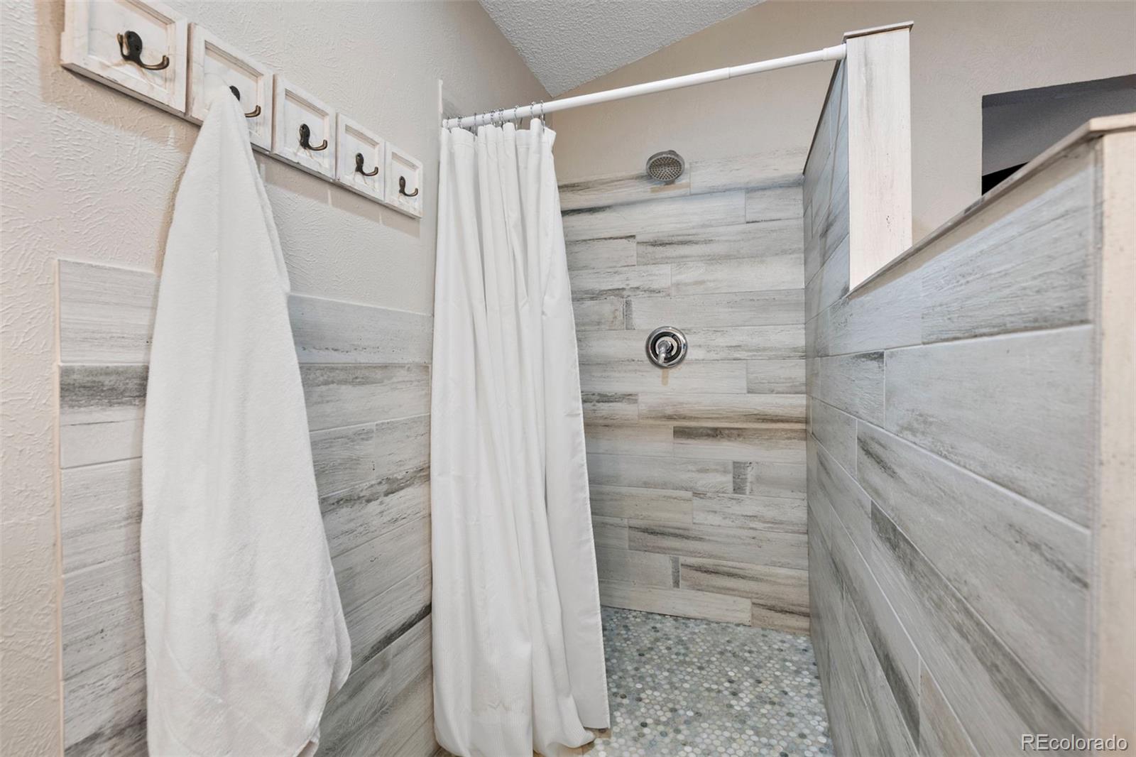 8482 Oak Street Arvada, CO 80005 - Photo 21 of 34 a bathroom with a shower
