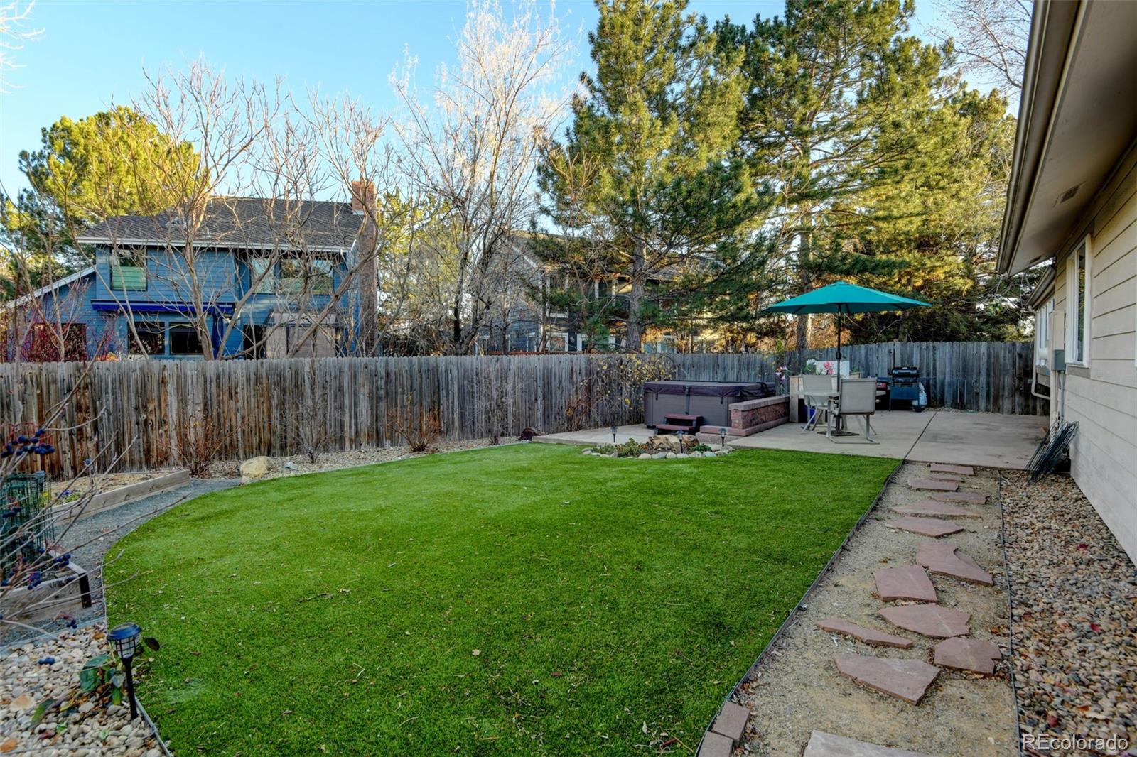 8482 Oak Street Arvada, CO 80005 - Photo 25 of 34 a backyard of a house with table and chairs