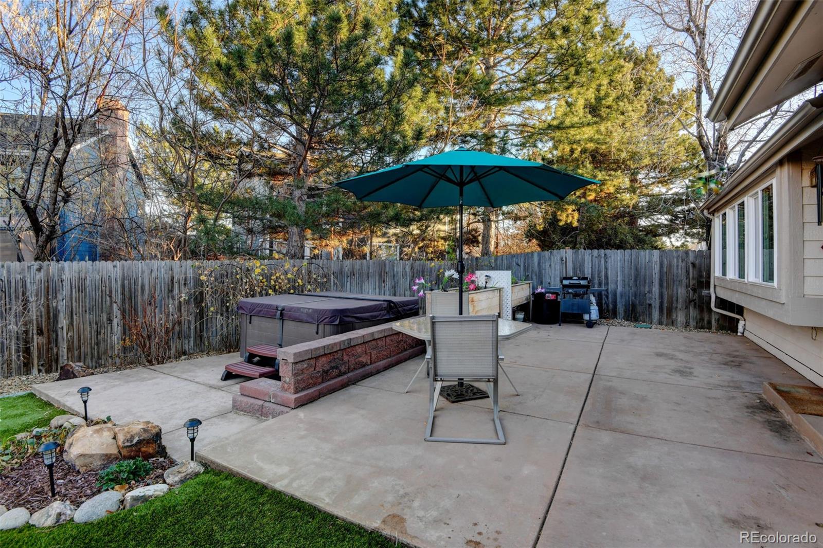 8482 Oak Street Arvada, CO 80005 - Photo 28 of 34 a view of backyard with outdoor seating and trees