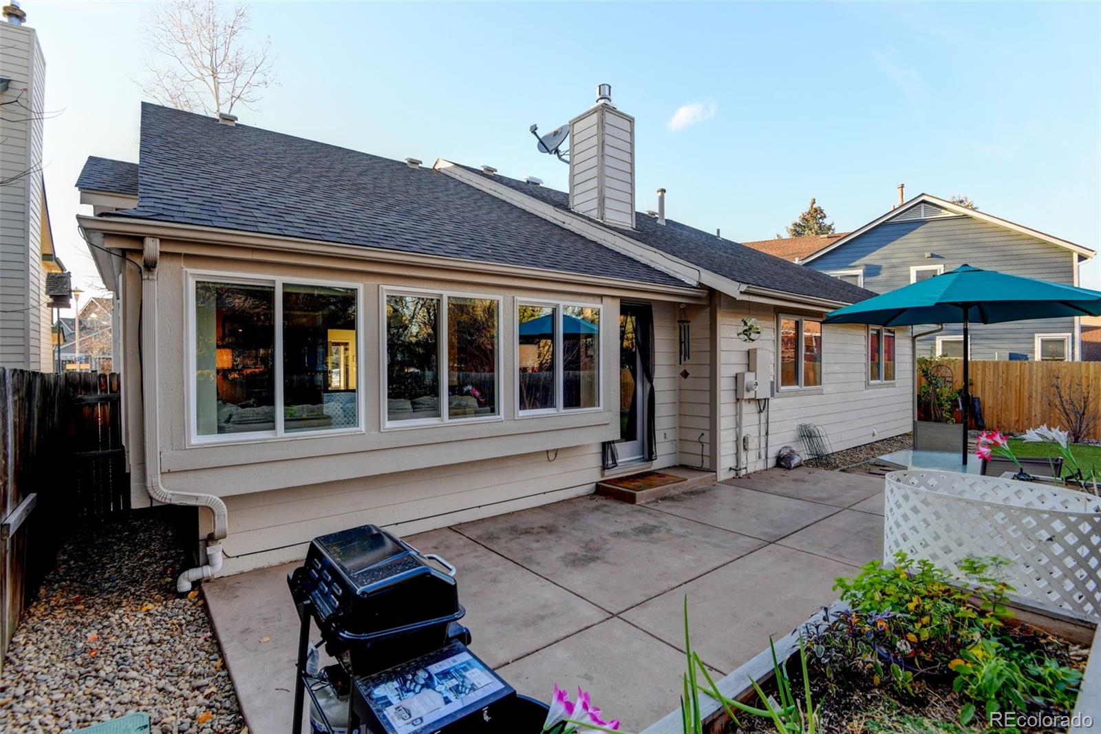 8482 Oak Street Arvada, CO 80005 - Photo 31 of 34 a front view of a house with a garden