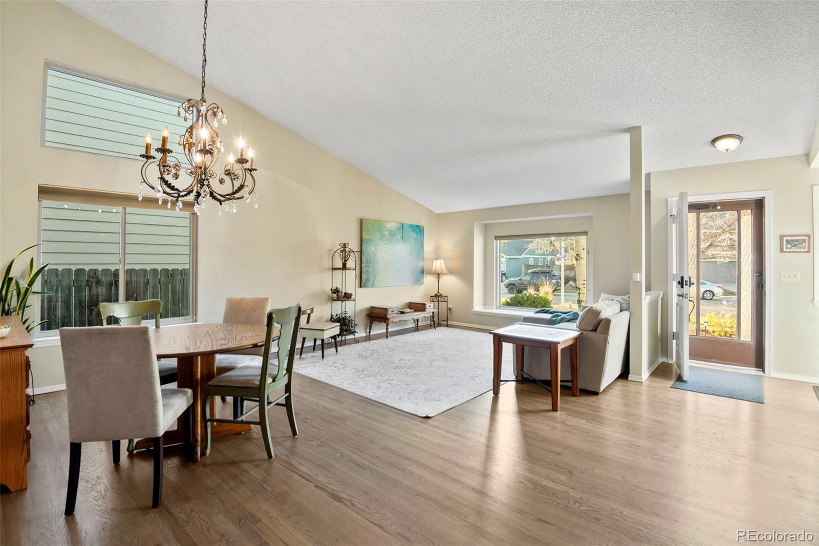 8482 Oak Street Arvada, CO 80005 - Photo 4 of 34 a view of a dining room with furniture window and wooden floor