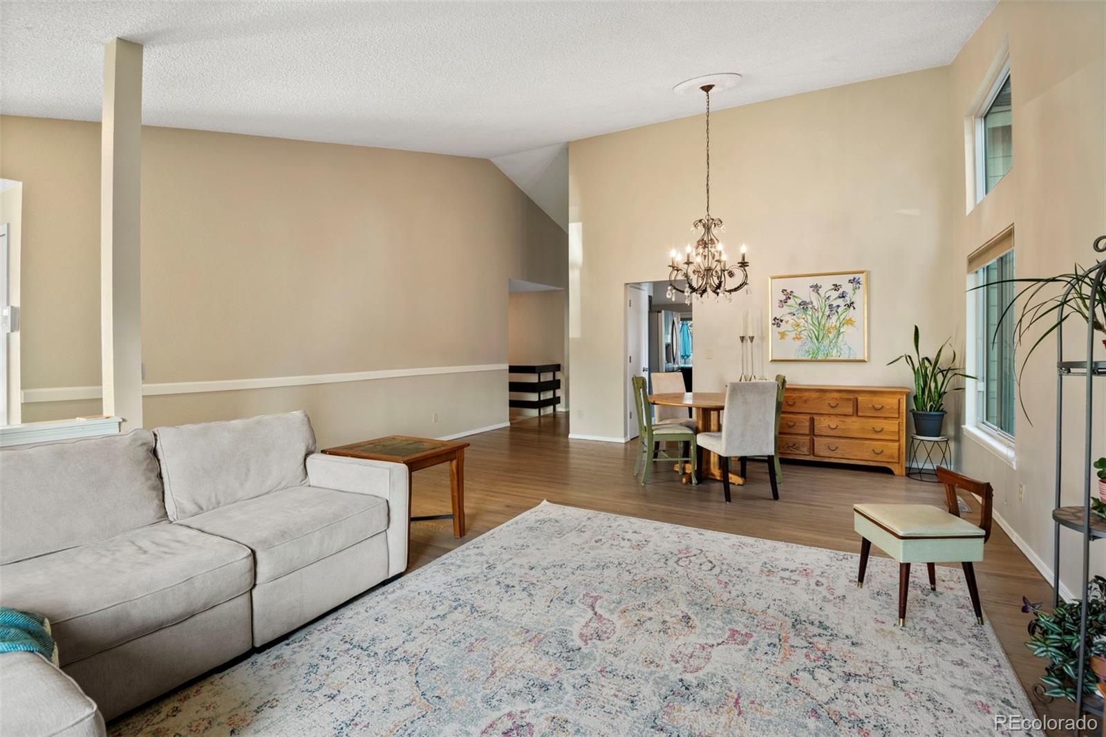 8482 Oak Street Arvada, CO 80005 - Photo 5 of 34 a living room with furniture and a chandelier