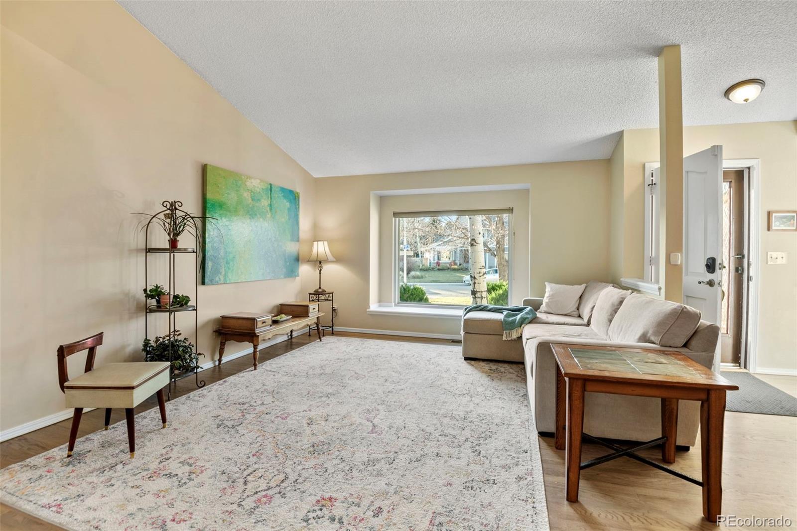 8482 Oak Street Arvada, CO 80005 - Photo 6 of 34 a living room with furniture and a window
