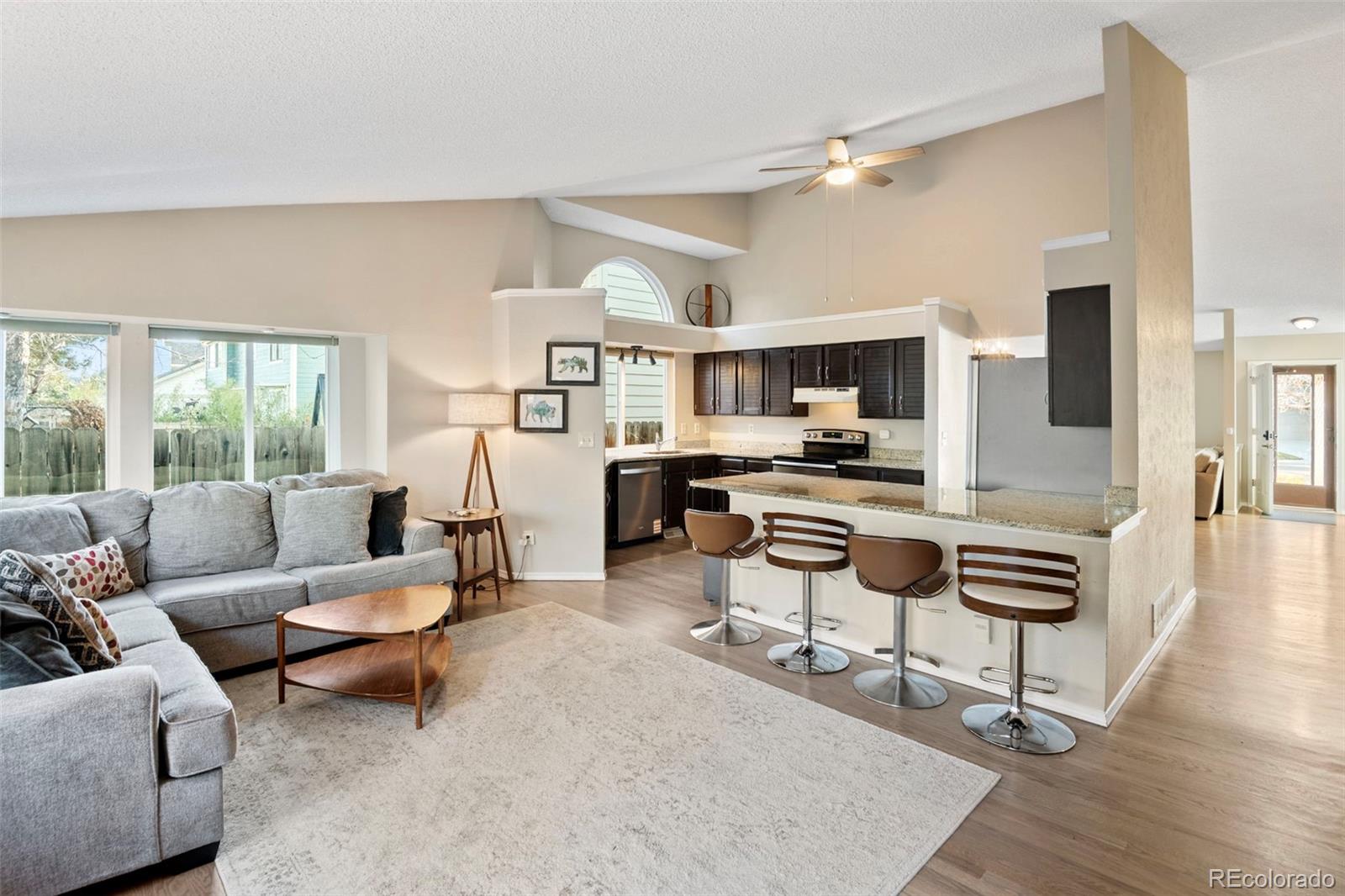 8482 Oak Street Arvada, CO 80005 - Photo 10 of 34 a living room with furniture and a large window