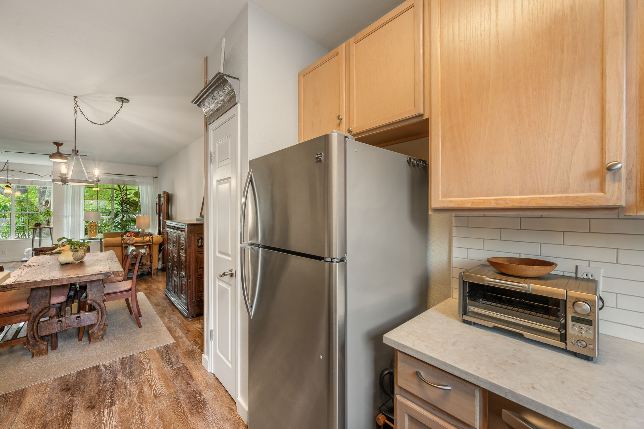 12401 Los Indios Trail, Unit 32 Austin, TX 78729 - Photo 5 of 39 A streamlined kitchen flows into the dining and living area with ample natural light.