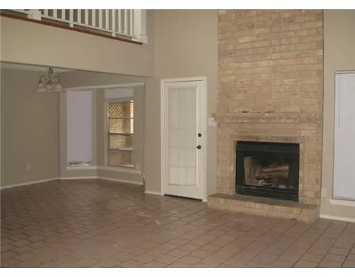 a view of an empty room with a fireplace