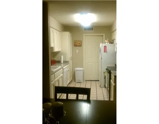 a view of a room with a dining table and chairs