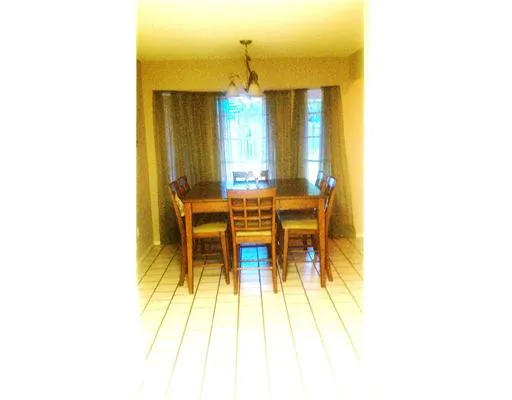 a view of a living room with a table and chairs