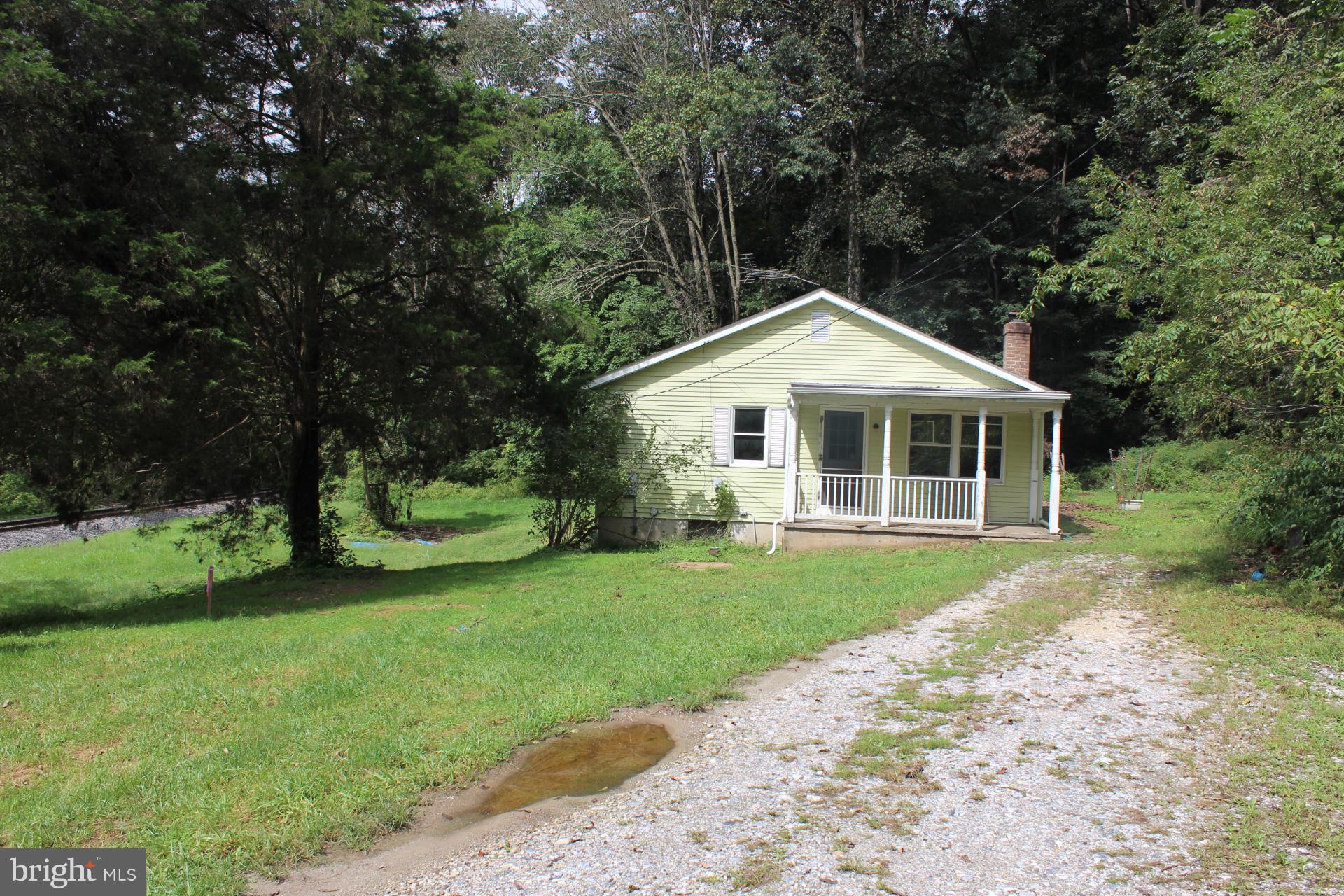 1556 Tank Road Finksburg, MD 21048 - Photo 3 of 12 a front view of a house with a garden