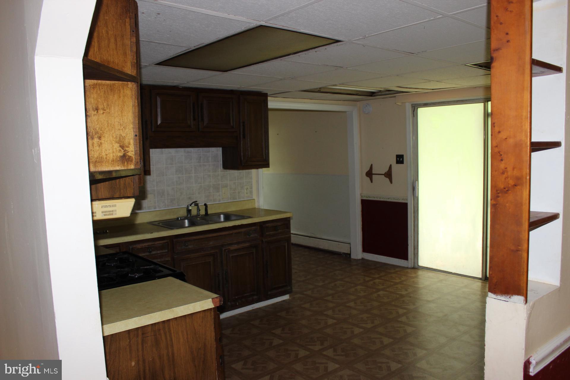 1556 Tank Road Finksburg, MD 21048 - Photo 8 of 12 a kitchen with a sink and a refrigerator